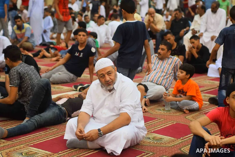 Egyptian Muslims attend the morning prayers for Eid al-Fitr celebrations, which marks the end of the holy fasting month of Ramadan, outside Amr Ibn El-Aas mosque, in Cairo, Egypt, on July 06, 2016. Photo by Amr Sayed