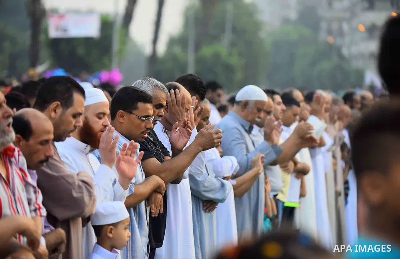 Egyptian Muslims attend the morning prayers for Eid al-Fitr celebrations, which marks the end of the holy fasting month of Ramadan, outside Amr Ibn El-Aas mosque, in Cairo, Egypt, on July 06, 2016. Photo by Amr Sayed