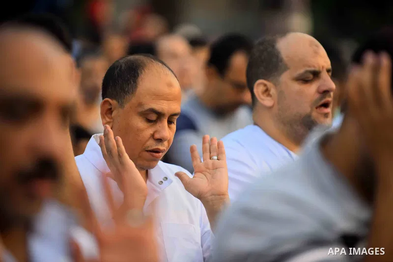 Egyptian Muslims attend the morning prayers for Eid al-Fitr celebrations, which marks the end of the holy fasting month of Ramadan, outside Amr Ibn El-Aas mosque, in Cairo, Egypt, on July 06, 2016. Photo by Amr Sayed