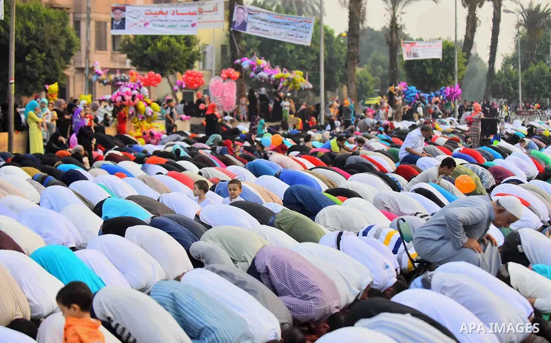 Egyptian Muslims attend the morning prayers for Eid al-Fitr celebrations, which marks the end of the holy fasting month of Ramadan, outside Amr Ibn El-Aas mosque, in Cairo, Egypt, on July 06, 2016. Photo by Amr Sayed