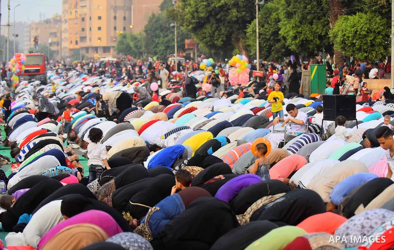 Egyptian Muslims attend the morning prayers for Eid al-Fitr celebrations, which marks the end of the holy fasting month of Ramadan, outside Amr Ibn El-Aas mosque, in Cairo, Egypt, on July 06, 2016. Photo by Amr Sayed