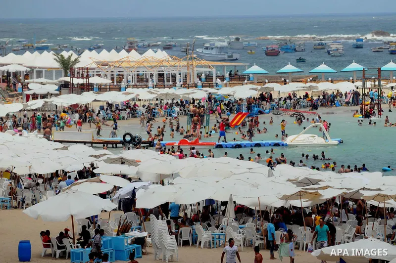Egyptians crowd a slide at a public beach on the first day of Eid al-Fitr celebrations, which marks the end of the holy fasting month of Ramadan, in the Mediterranean city of Alexandria, in the north of Cairo July 6, 201...