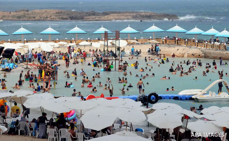 Egyptians crowd a slide at a public beach on the first day of Eid al-Fitr celebrations, which marks the end of the holy fasting month of Ramadan, in the Mediterranean city of Alexandria, in the north of Cairo July 6, 201...