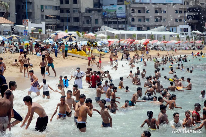 Egyptians crowd a slide at a public beach on the first day of Eid al-Fitr celebrations, which marks the end of the holy fasting month of Ramadan, in the Mediterranean city of Alexandria, in the north of Cairo July 6, 201...