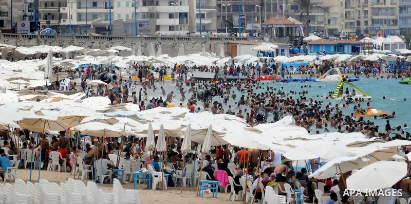 Egyptians crowd a slide at a public beach on the first day of Eid al-Fitr celebrations, which marks the end of the holy fasting month of Ramadan, in the Mediterranean city of Alexandria, in the north of Cairo July 6, 201...
