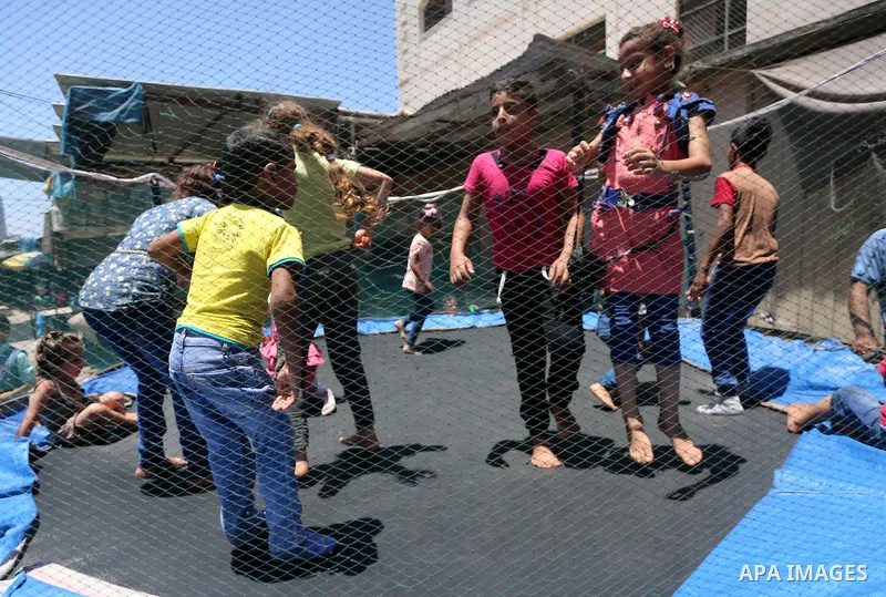 Palestinian children play on the second day of of Eid al-Fitr celebrations, which marks the end of the holy fasting month of Ramadan, at the al-Shati refugee camp in Gaza City on July 7, 2016. Photo by Mohammed Asad
