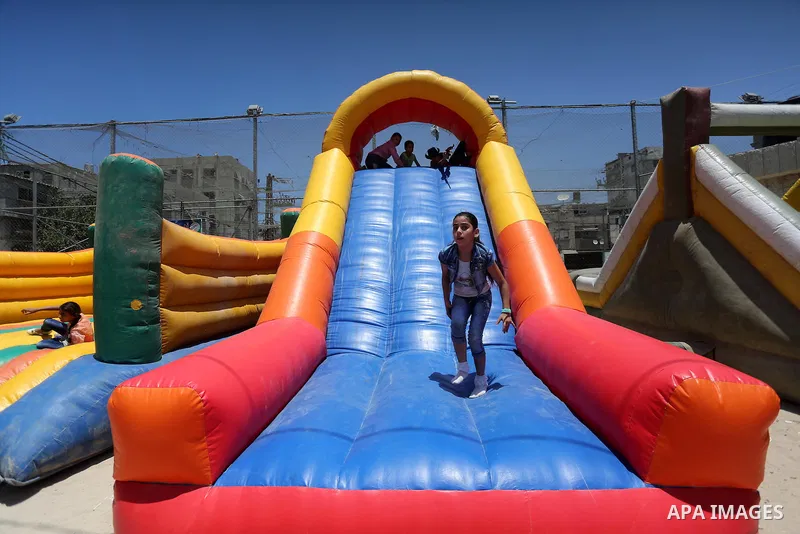 Palestinian children play on the second day of of Eid al-Fitr celebrations, which marks the end of the holy fasting month of Ramadan, at the al-Shati refugee camp in Gaza City on July 7, 2016. Photo by Mohammed Asad