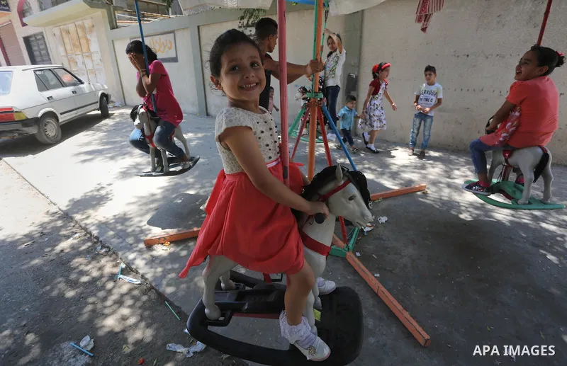 Palestinian children play on the second day of of Eid al-Fitr celebrations, which marks the end of the holy fasting month of Ramadan, at the al-Shati refugee camp in Gaza City on July 7, 2016. Photo by Mohammed Asad