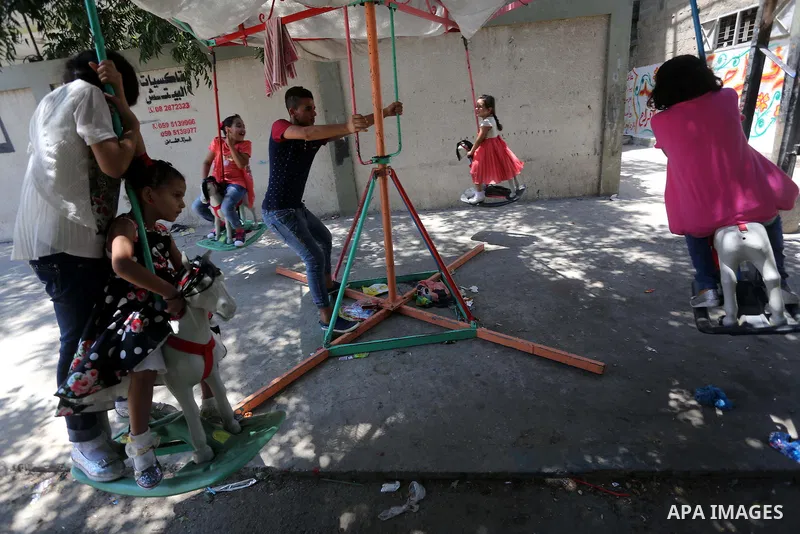 Palestinian children play on the second day of of Eid al-Fitr celebrations, which marks the end of the holy fasting month of Ramadan, at the al-Shati refugee camp in Gaza City on July 7, 2016. Photo by Mohammed Asad