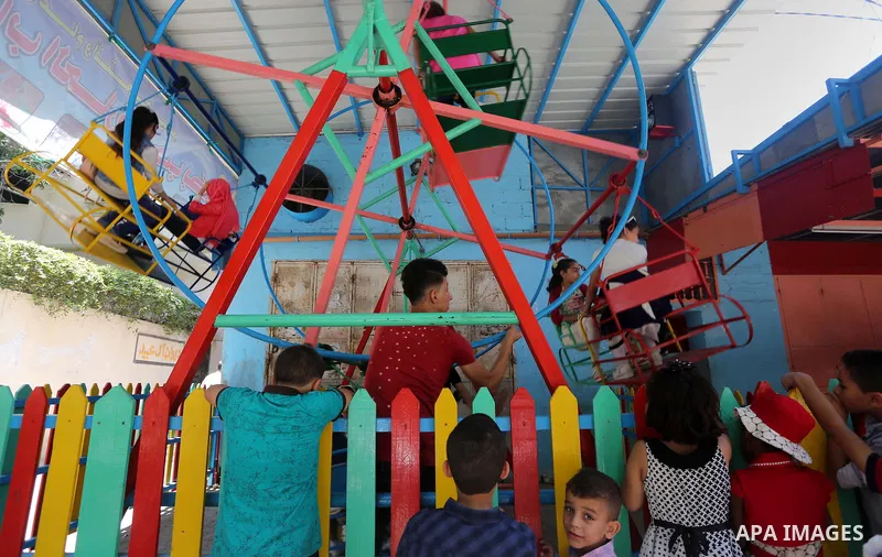 Palestinian children play on the second day of of Eid al-Fitr celebrations, which marks the end of the holy fasting month of Ramadan, at the al-Shati refugee camp in Gaza City on July 7, 2016. Photo by Mohammed Asad