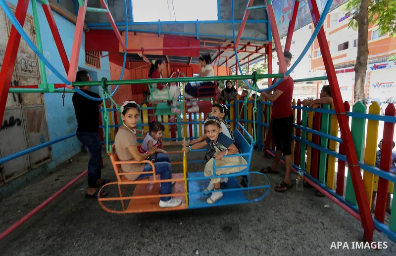 Palestinian children play on the second day of of Eid al-Fitr celebrations, which marks the end of the holy fasting month of Ramadan, at the al-Shati refugee camp in Gaza City on July 7, 2016. Photo by Mohammed Asad