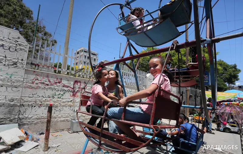 Palestinian children play on the second day of of Eid al-Fitr celebrations, which marks the end of the holy fasting month of Ramadan, at the al-Shati refugee camp in Gaza City on July 7, 2016. Photo by Mohammed Asad
