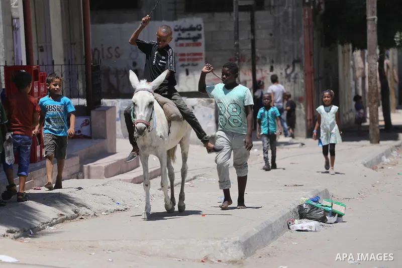 Palestinian children play on the second day of of Eid al-Fitr celebrations, which marks the end of the holy fasting month of Ramadan, at the al-Shati refugee camp in Gaza City on July 7, 2016. Photo by Mohammed Asad