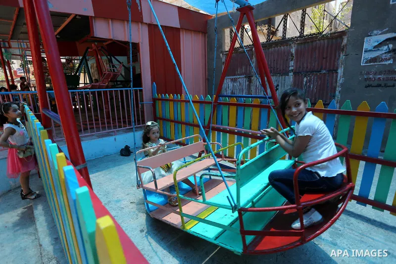 Palestinian children play on the second day of of Eid al-Fitr celebrations, which marks the end of the holy fasting month of Ramadan, at the al-Shati refugee camp in Gaza City on July 7, 2016. Photo by Mohammed Asad