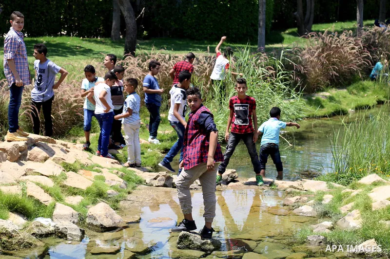 Egyptians play at a garden on the second day of of Eid al-Fitr celebrations, which marks the end of the holy fasting month of Ramadan, in Cairo, Egypt, on July 7, 2016. Photo by Amr Sayed