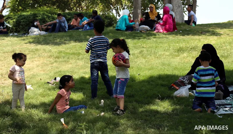 Egyptians play at a garden on the second day of of Eid al-Fitr celebrations, which marks the end of the holy fasting month of Ramadan, in Cairo, Egypt, on July 7, 2016. Photo by Amr Sayed