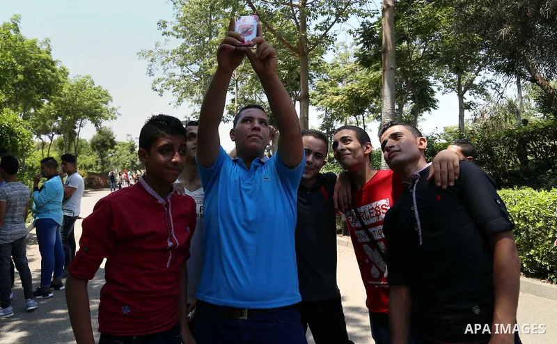 Egyptians play at a garden on the second day of of Eid al-Fitr celebrations, which marks the end of the holy fasting month of Ramadan, in Cairo, Egypt, on July 7, 2016. Photo by Amr Sayed