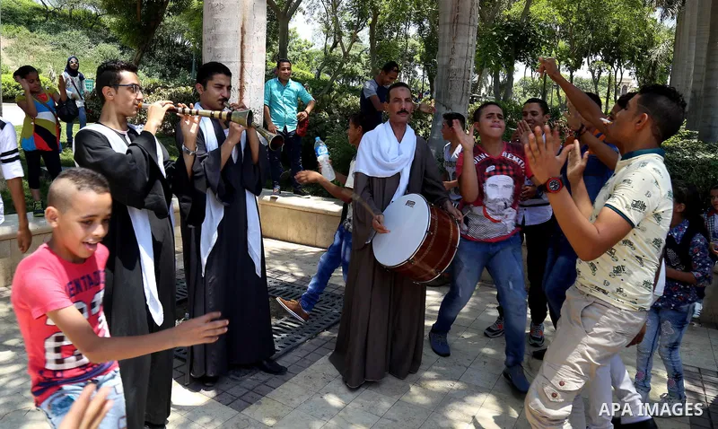 Egyptians play at a garden on the second day of of Eid al-Fitr celebrations, which marks the end of the holy fasting month of Ramadan, in Cairo, Egypt, on July 7, 2016. Photo by Amr Sayed