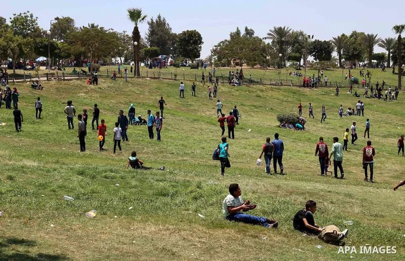 Egyptians play at a garden on the second day of of Eid al-Fitr celebrations, which marks the end of the holy fasting month of Ramadan, in Cairo, Egypt, on July 7, 2016. Photo by Amr Sayed