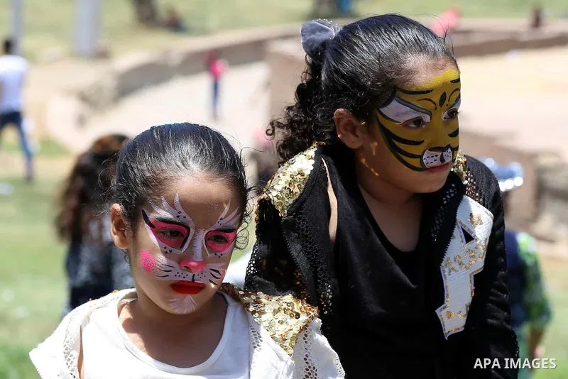 Egyptians play at a garden on the second day of of Eid al-Fitr celebrations, which marks the end of the holy fasting month of Ramadan, in Cairo, Egypt, on July 7, 2016. Photo by Amr Sayed