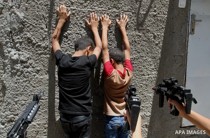 Palestinian boys play with toy guns to celebrate Eid al-Fitr during the second day of the holiday of Eid al-Fitr marking the end of Islam's fasting holy month of Ramadan, in Rafah in the southern Gaza strip, on July 7, 2...