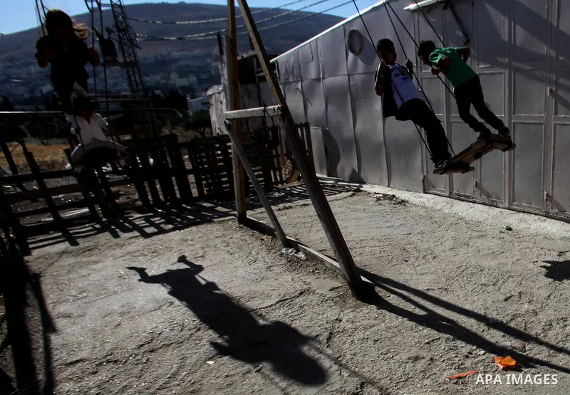 Palestinian children play to celebrate Eid al-Fitr during the second day of the holiday of Eid al-Fitr marking the end of Islam's fasting holy month of Ramadan, in the West Bank city of Nablus, on July 7, 2016. Photo by...
