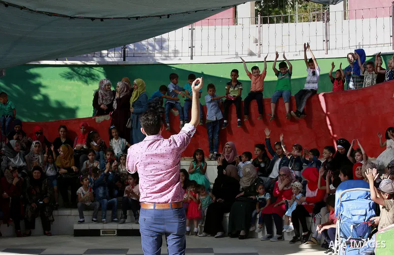 Palestinian children play to celebrate Eid al-Fitr during the second day of the holiday of Eid al-Fitr marking the end of Islam's fasting holy month of Ramadan, in the West Bank city of Hebron, on July 7, 2016. Photo by...