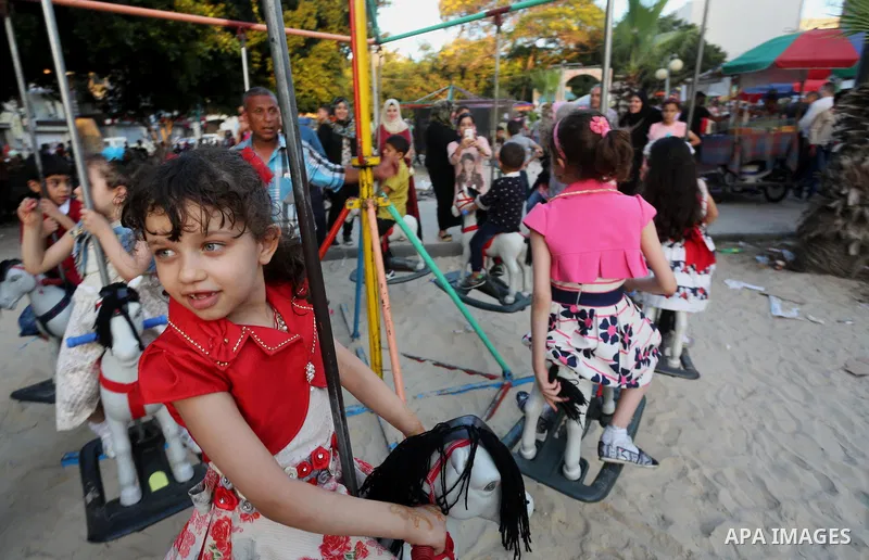 Palestinian children play on the second day of of Eid al-Fitr celebrations, which marks the end of the holy fasting month of Ramadan, in Gaza City on July 7, 2016. Photo by Mohammed Asad