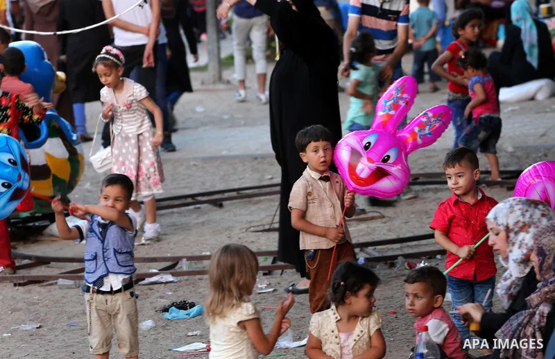 Palestinian children play on the second day of of Eid al-Fitr celebrations, which marks the end of the holy fasting month of Ramadan, in Gaza City on July 7, 2016. Photo by Mohammed Asad