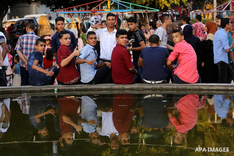 Palestinian youths pose for a photo to celebrate Eid al-Fitr during the second day of the holiday of Eid al-Fitr marking the end of Islam's fasting holy month of Ramadan, in Gaza City on July 7, 2016. Photo by Mohammed A...