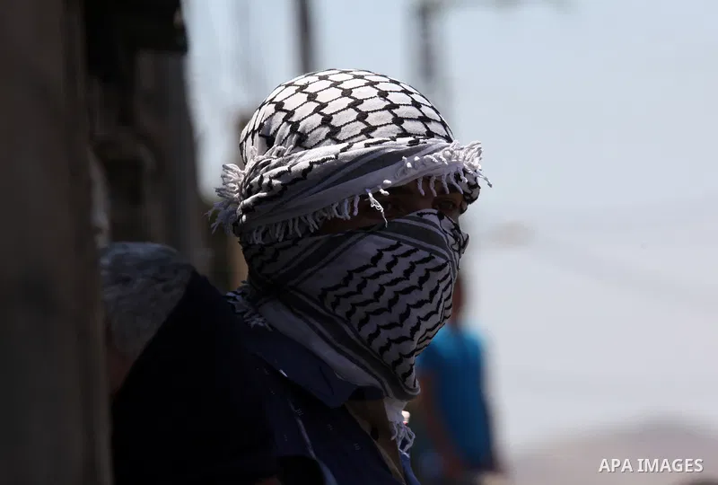 A Palestinian protester looks on during clashes with Israeli security forces following a demonstration against the expropriation of Palestinian land by Israel on July 08, 2016 in the village of Kfar Qaddum, near Nablus,...