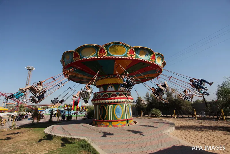 Palestinians take a ride at an amusement park on the third day of Eid al-Fitr holiday which marks the end of the Muslim holy month of Ramadan, in Gaza City on July 08, 2016. Photo by Ashraf Amra