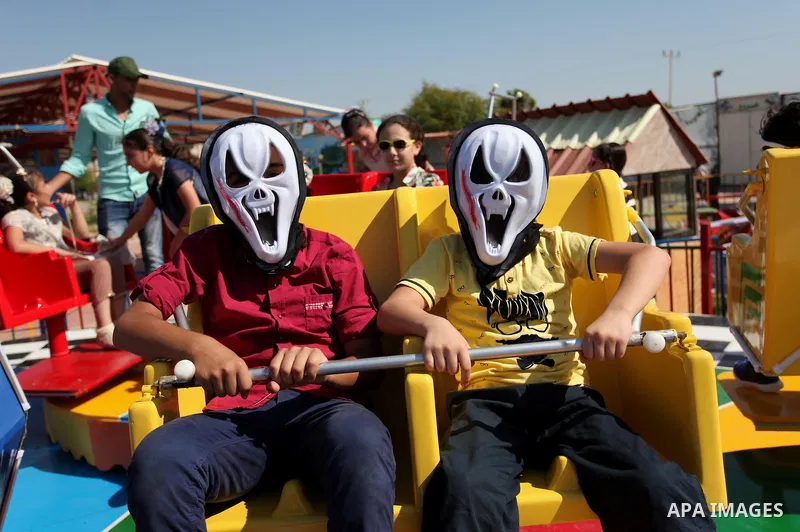 Palestinian children play at an amusement park on the third day of Eid al-Fitr holiday which marks the end of the Muslim holy month of Ramadan, in Gaza City on July 08, 2016. Photo by Ashraf Amra
