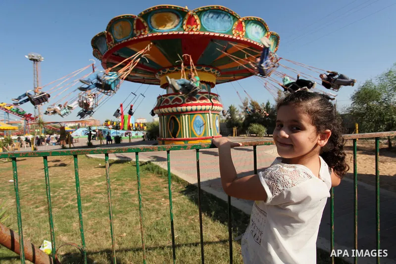 Palestinians take a ride at an amusement park on the third day of Eid al-Fitr holiday which marks the end of the Muslim holy month of Ramadan, in Gaza City on July 08, 2016. Photo by Ashraf Amra