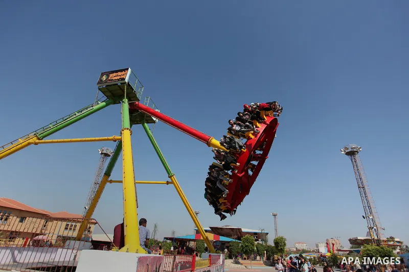Palestinians take a ride at an amusement park on the third day of Eid al-Fitr holiday which marks the end of the Muslim holy month of Ramadan, in Gaza City on July 08, 2016. Photo by Ashraf Amra