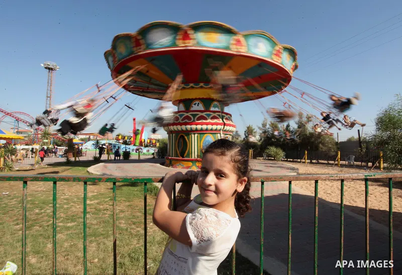 Palestinians take a ride at an amusement park on the third day of Eid al-Fitr holiday which marks the end of the Muslim holy month of Ramadan, in Gaza City on July 08, 2016. Photo by Ashraf Amra