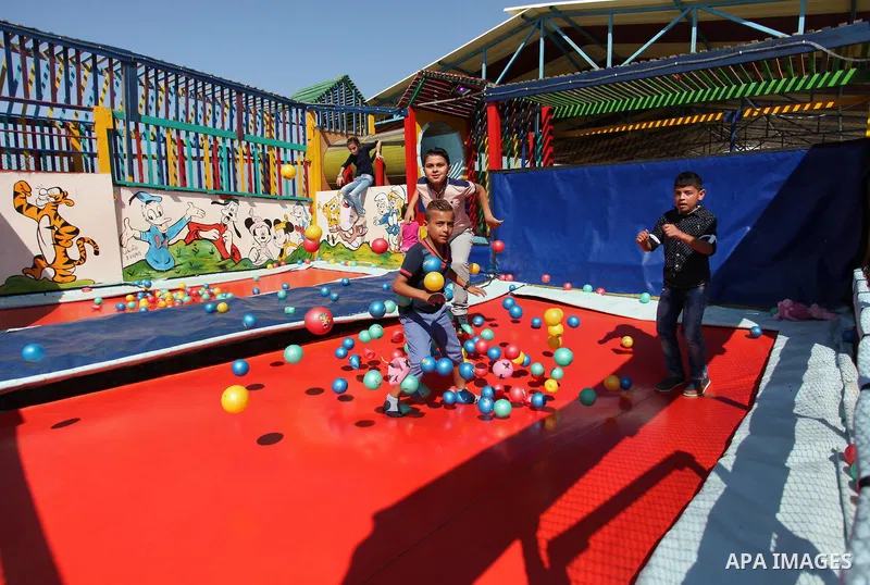 Palestinian children play at an amusement park on the third day of Eid al-Fitr holiday which marks the end of the Muslim holy month of Ramadan, in Gaza City on July 08, 2016. Photo by Ashraf Amra