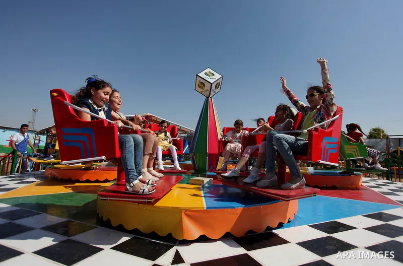 Palestinian children play at an amusement park on the third day of Eid al-Fitr holiday which marks the end of the Muslim holy month of Ramadan, in Gaza City on July 08, 2016. Photo by Ashraf Amra