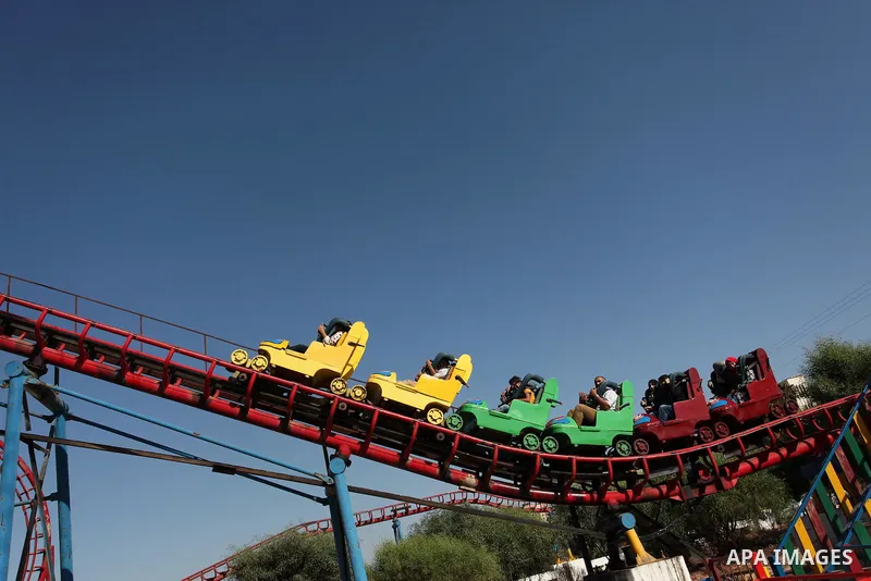 Palestinians take a ride at an amusement park on the third day of Eid al-Fitr holiday which marks the end of the Muslim holy month of Ramadan, in Gaza City on July 08, 2016. Photo by Ashraf Amra