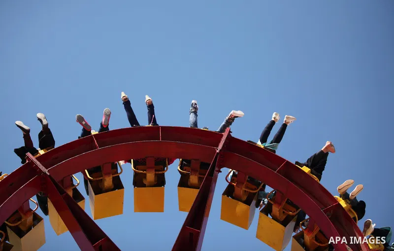 Palestinians take a ride at an amusement park on the third day of Eid al-Fitr holiday which marks the end of the Muslim holy month of Ramadan, in Gaza City on July 08, 2016. Photo by Ashraf Amra