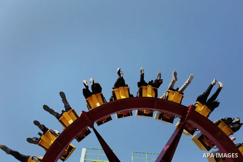 Palestinians take a ride at an amusement park on the third day of Eid al-Fitr holiday which marks the end of the Muslim holy month of Ramadan, in Gaza City on July 08, 2016. Photo by Ashraf Amra