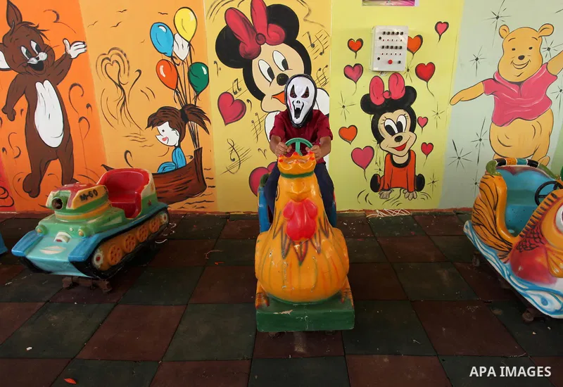 Palestinian children play at an amusement park on the third day of Eid al-Fitr holiday which marks the end of the Muslim holy month of Ramadan, in Gaza City on July 08, 2016. Photo by Ashraf Amra