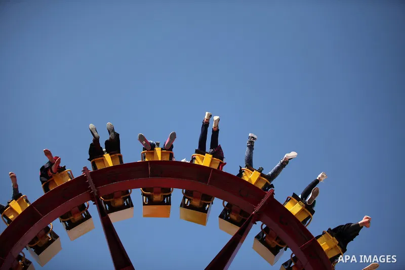 Palestinians take a ride at an amusement park on the third day of Eid al-Fitr holiday which marks the end of the Muslim holy month of Ramadan, in Gaza City on July 08, 2016. Photo by Ashraf Amra