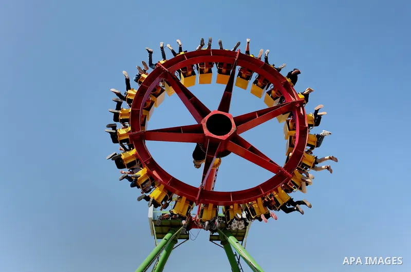 Palestinians take a ride at an amusement park on the third day of Eid al-Fitr holiday which marks the end of the Muslim holy month of Ramadan, in Gaza City on July 08, 2016. Photo by Ashraf Amra