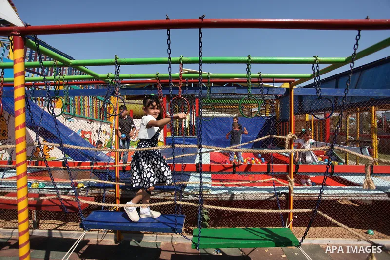 Palestinian children play at an amusement park on the third day of Eid al-Fitr holiday which marks the end of the Muslim holy month of Ramadan, in Gaza City on July 08, 2016. Photo by Ashraf Amra