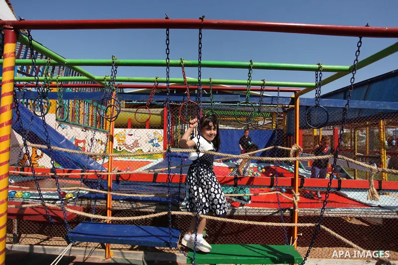 Palestinian children play at an amusement park on the third day of Eid al-Fitr holiday which marks the end of the Muslim holy month of Ramadan, in Gaza City on July 08, 2016. Photo by Ashraf Amra