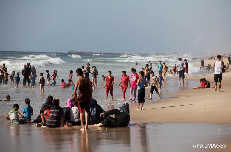 Palestinians enjoy a day at the beach of the Mediterranean sea on the coast of Gaza city, on the third day of Eid al-Fitr holiday which marks the end of the Muslim holy month of Ramadan, on July 08, 2016. Photo by Ashraf...