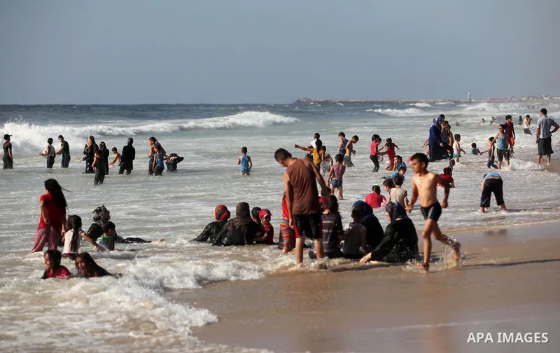 Palestinian children swim in the Mediterranean sea on the coast of Gaza city, on the third day of Eid al-Fitr holiday which marks the end of the Muslim holy month of Ramadan, on July 08, 2016. Photo by Ashraf Amra