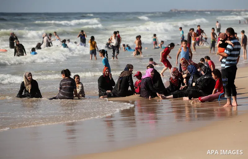 Palestinian children swim in the Mediterranean sea on the coast of Gaza city, on the third day of Eid al-Fitr holiday which marks the end of the Muslim holy month of Ramadan, on July 08, 2016. Photo by Ashraf Amra