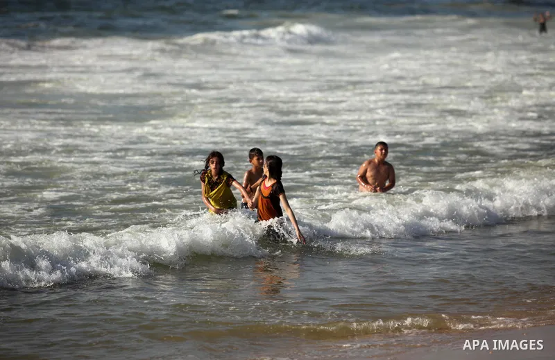 Palestinian children swim in the Mediterranean sea on the coast of Gaza city, on the third day of Eid al-Fitr holiday which marks the end of the Muslim holy month of Ramadan, on July 08, 2016. Photo by Ashraf Amra